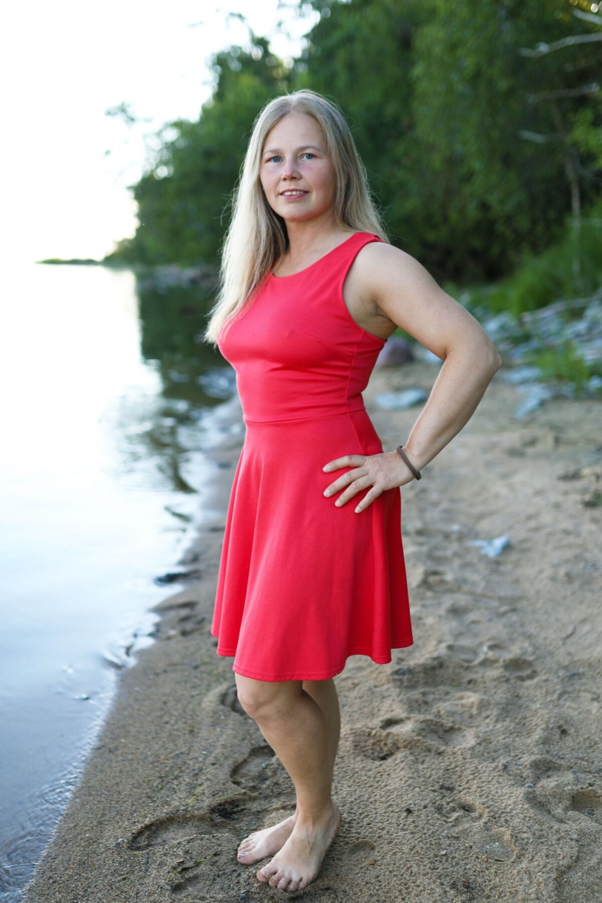 Blondine zieht sich am Strand aus