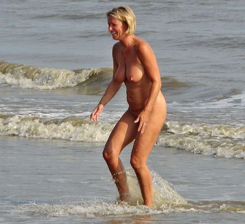 MILF nudiste sur la plage avec une superbe paire de seins