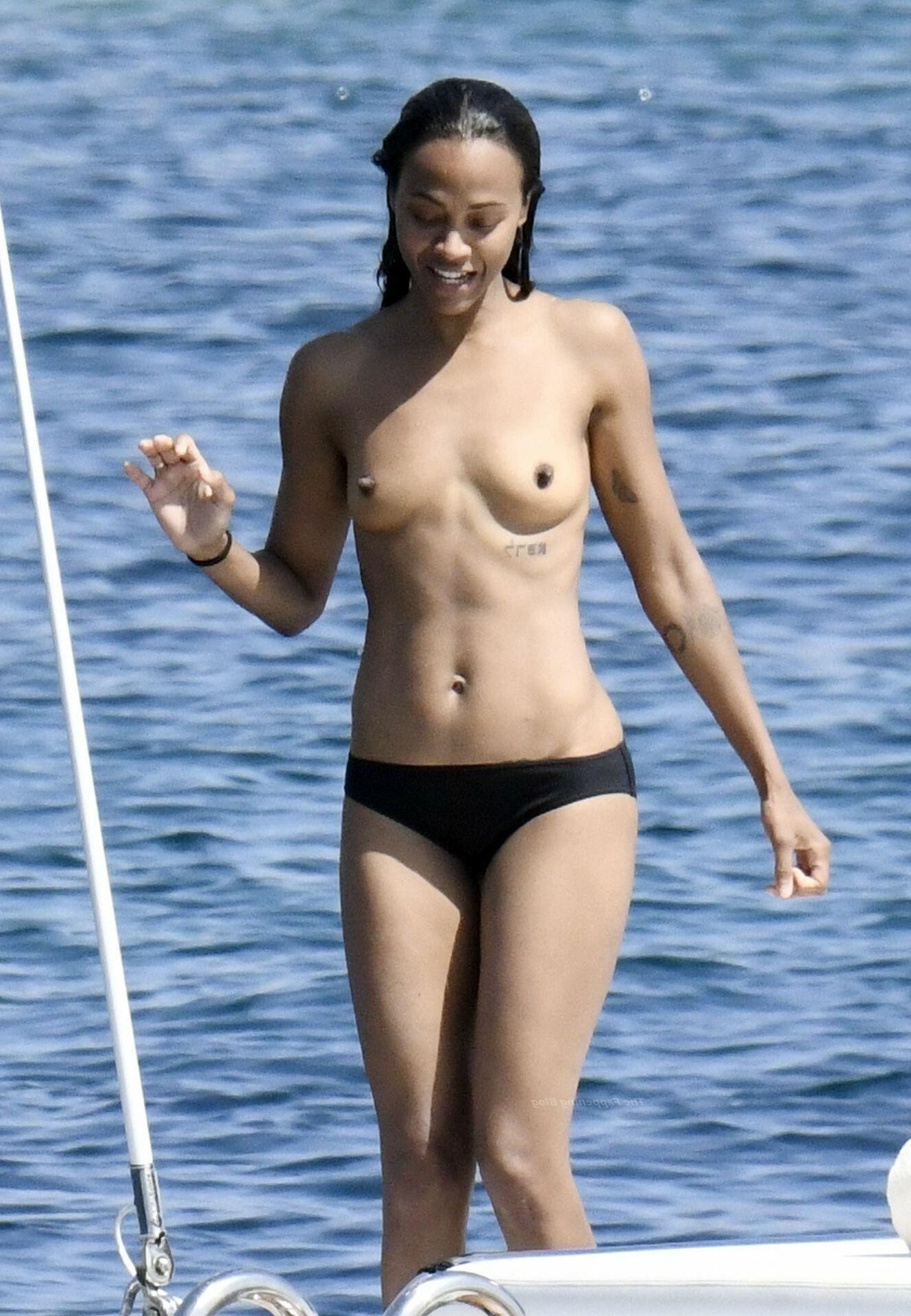 Zoe Saldana with her little tits out on the ocean