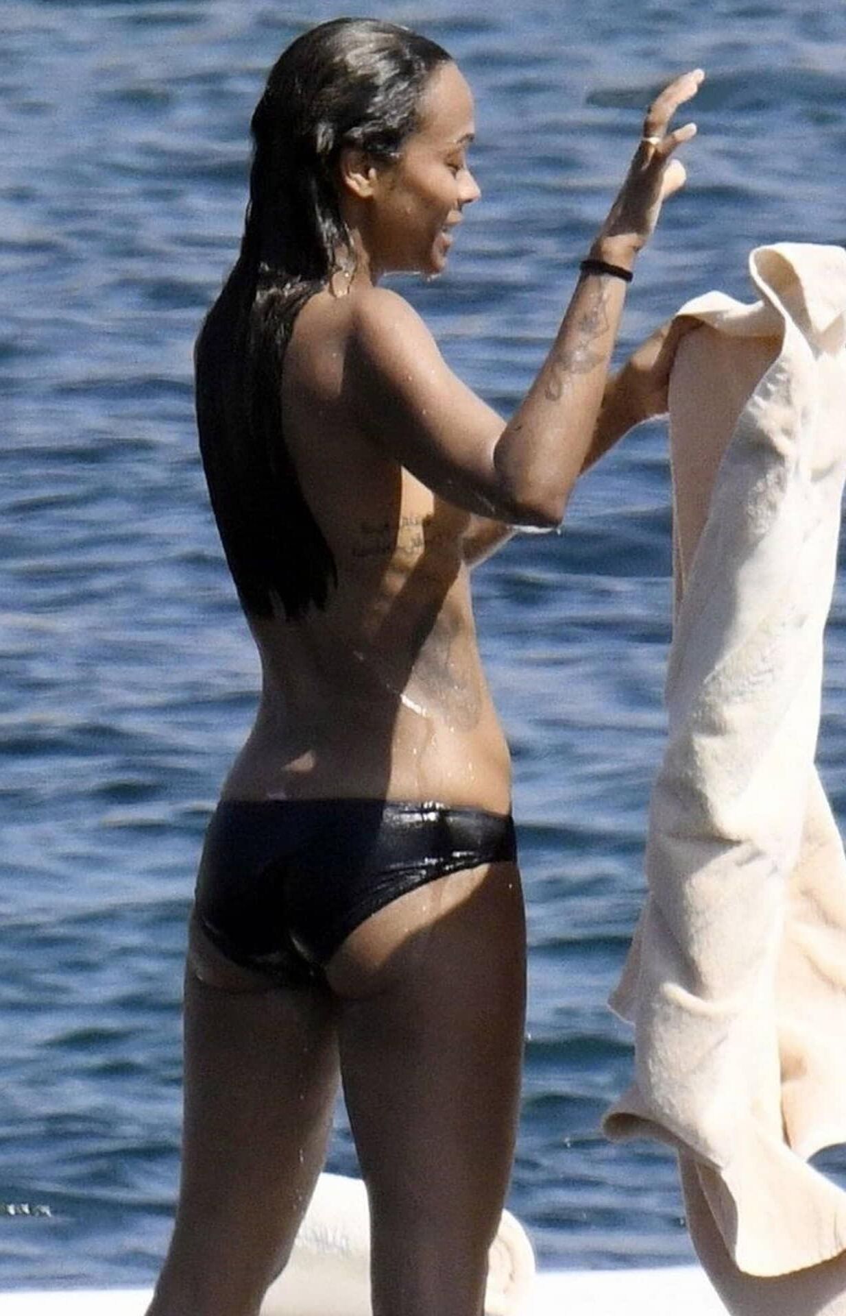 Zoe Saldana with her little tits out on the ocean