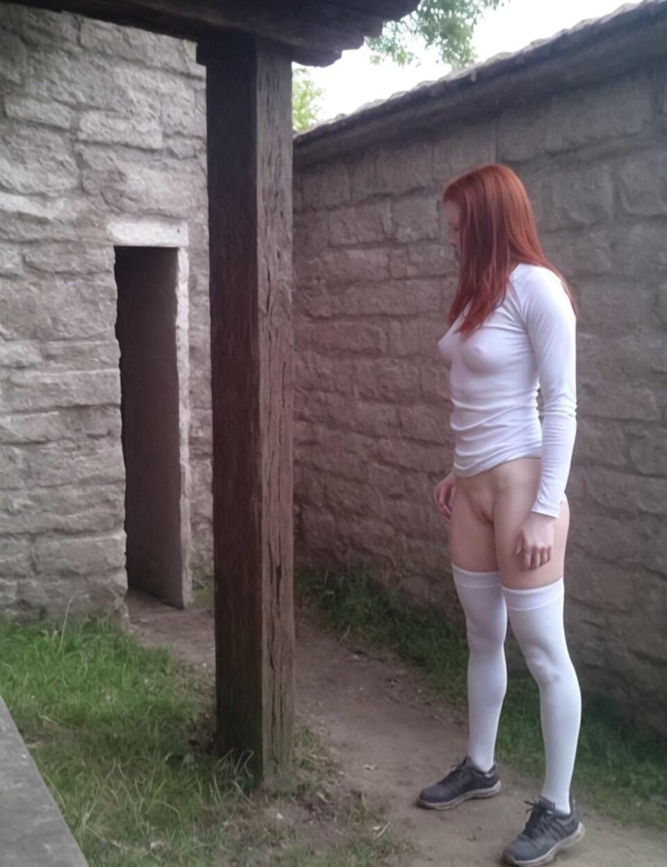 Bottomless redhead in stockings roaming ancient ruins