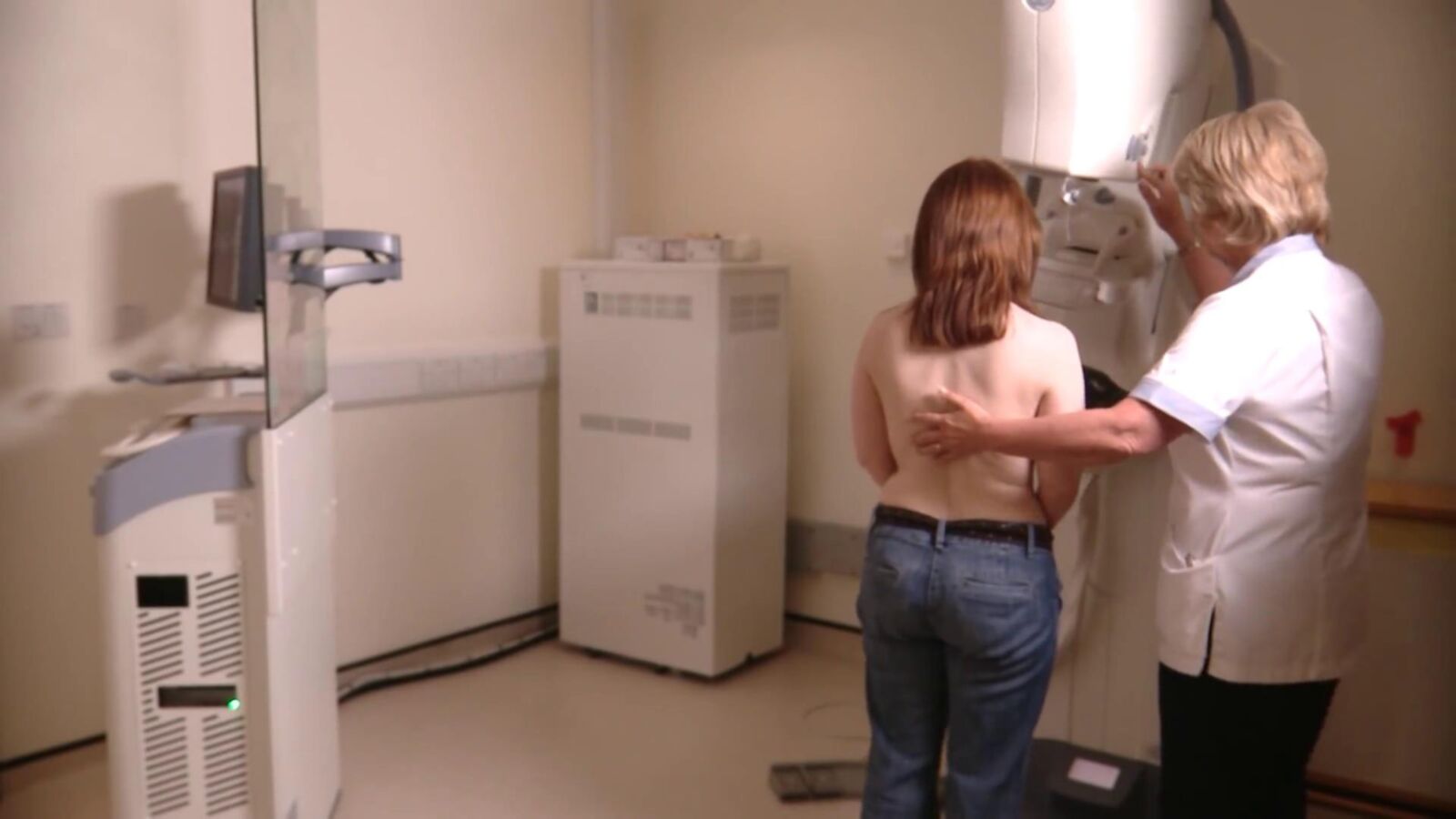 Mature redhead woman having a mammogram