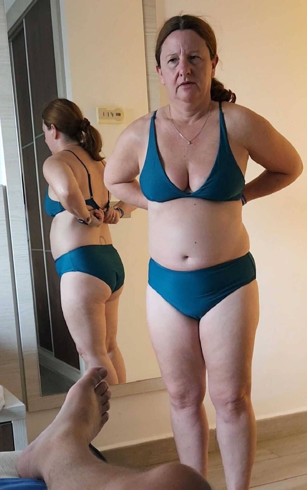 Chubby milf in various bikinis, non nude. 