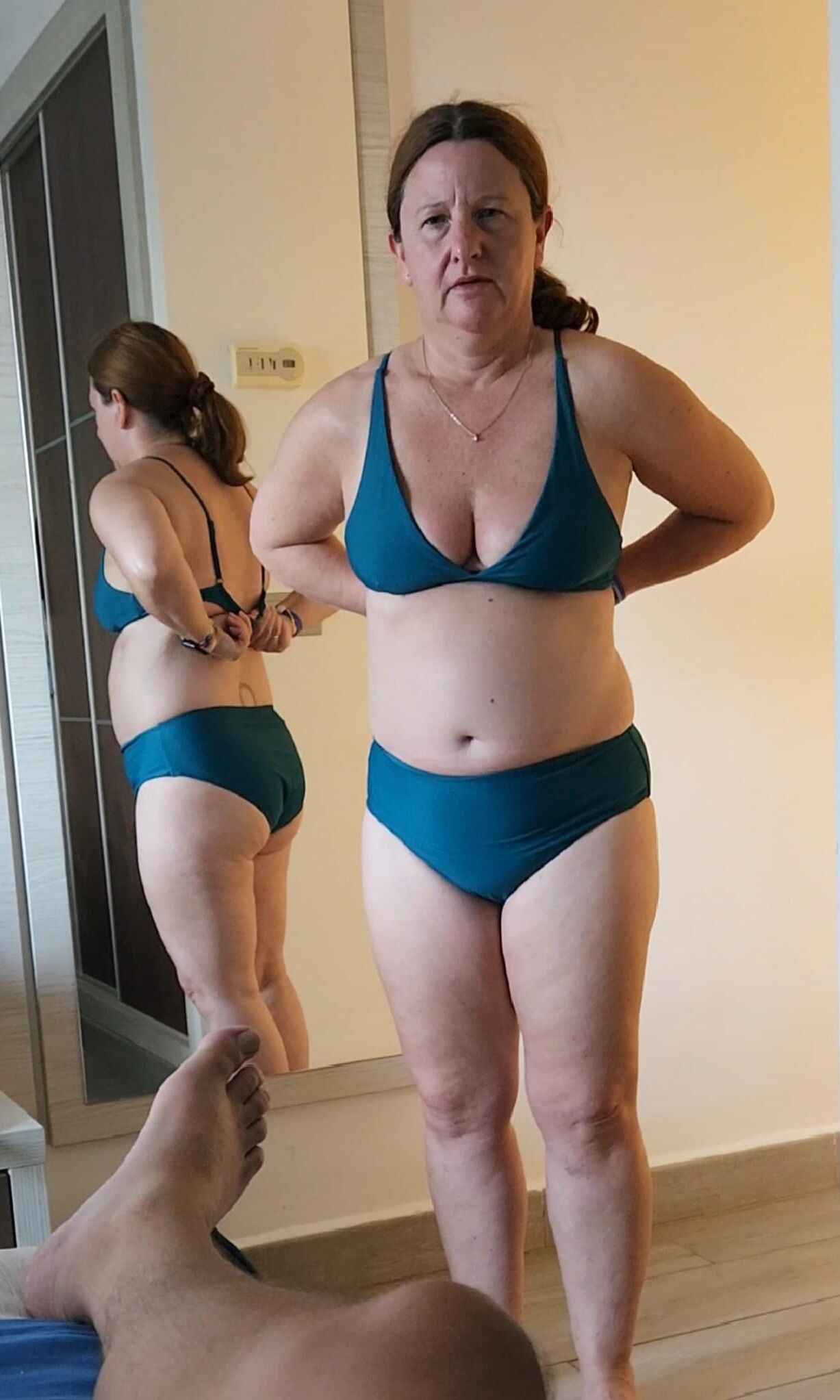 Chubby milf in various bikinis, non nude. 