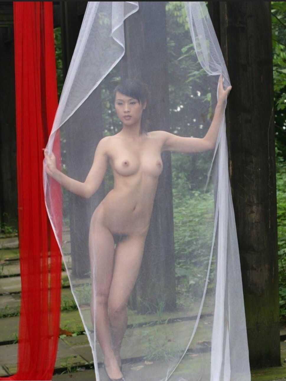 Chinese Slut Posing With a Pillar