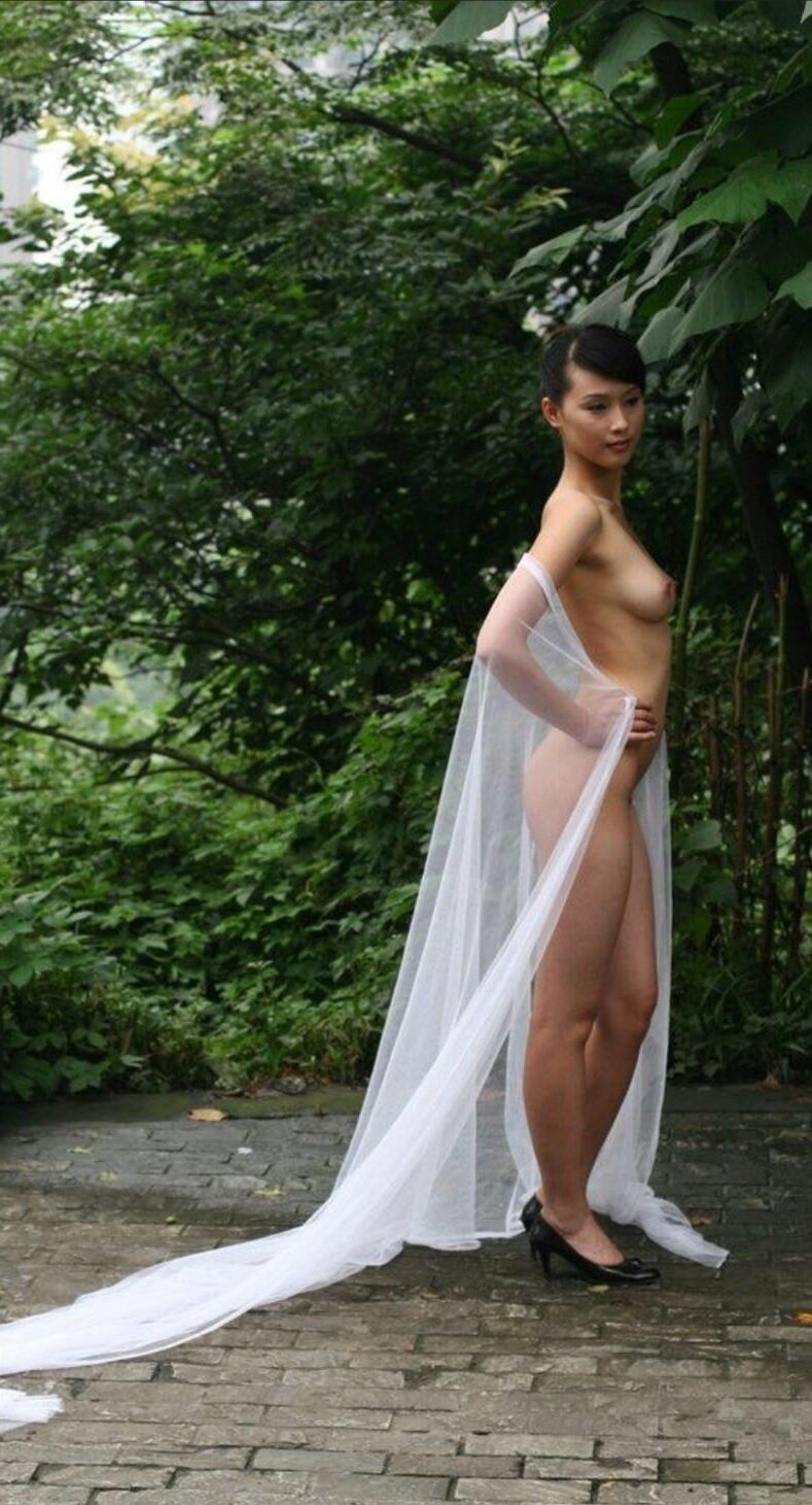 Chinese Slut Posing With a Pillar