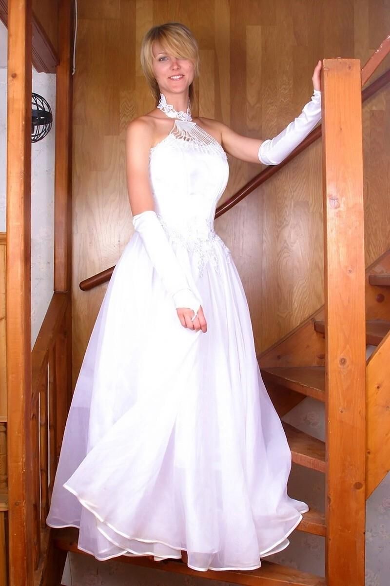 Blonde girl on stairs in wedding dress