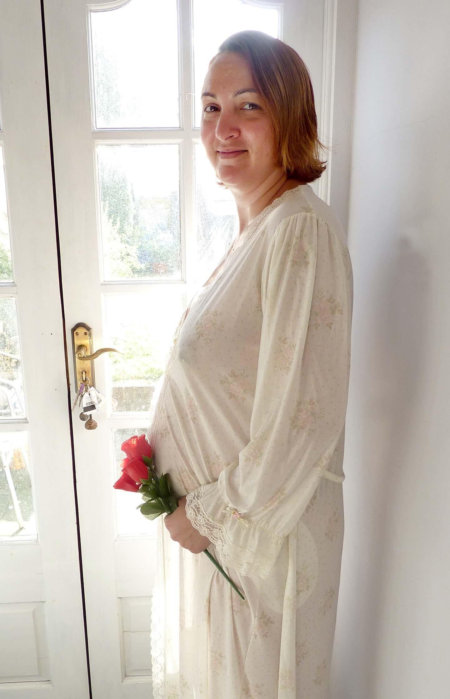 Pregnant wife in see through gown