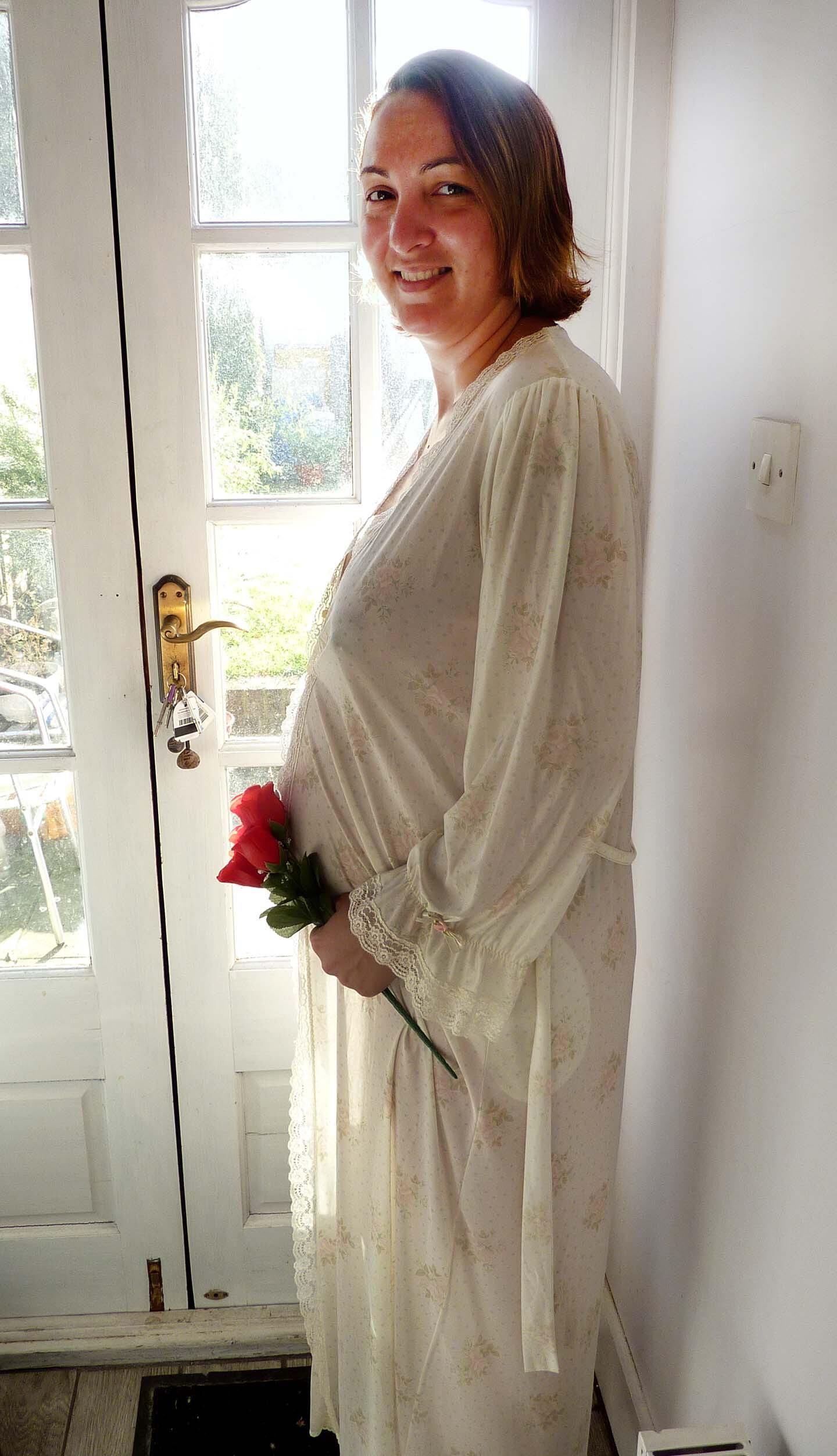 Pregnant wife in see through gown