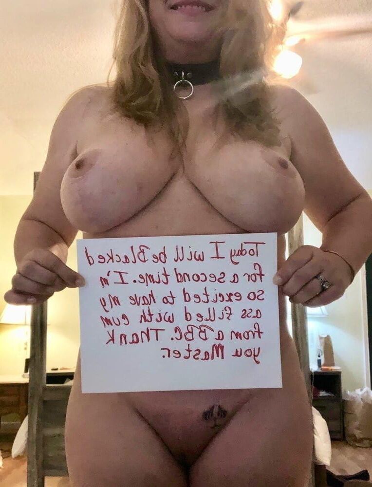 naked women holding signs 