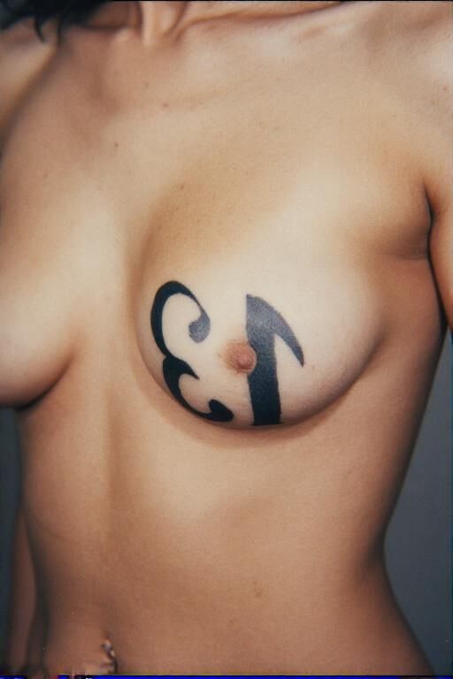 Gotta tattooed tit say number 
