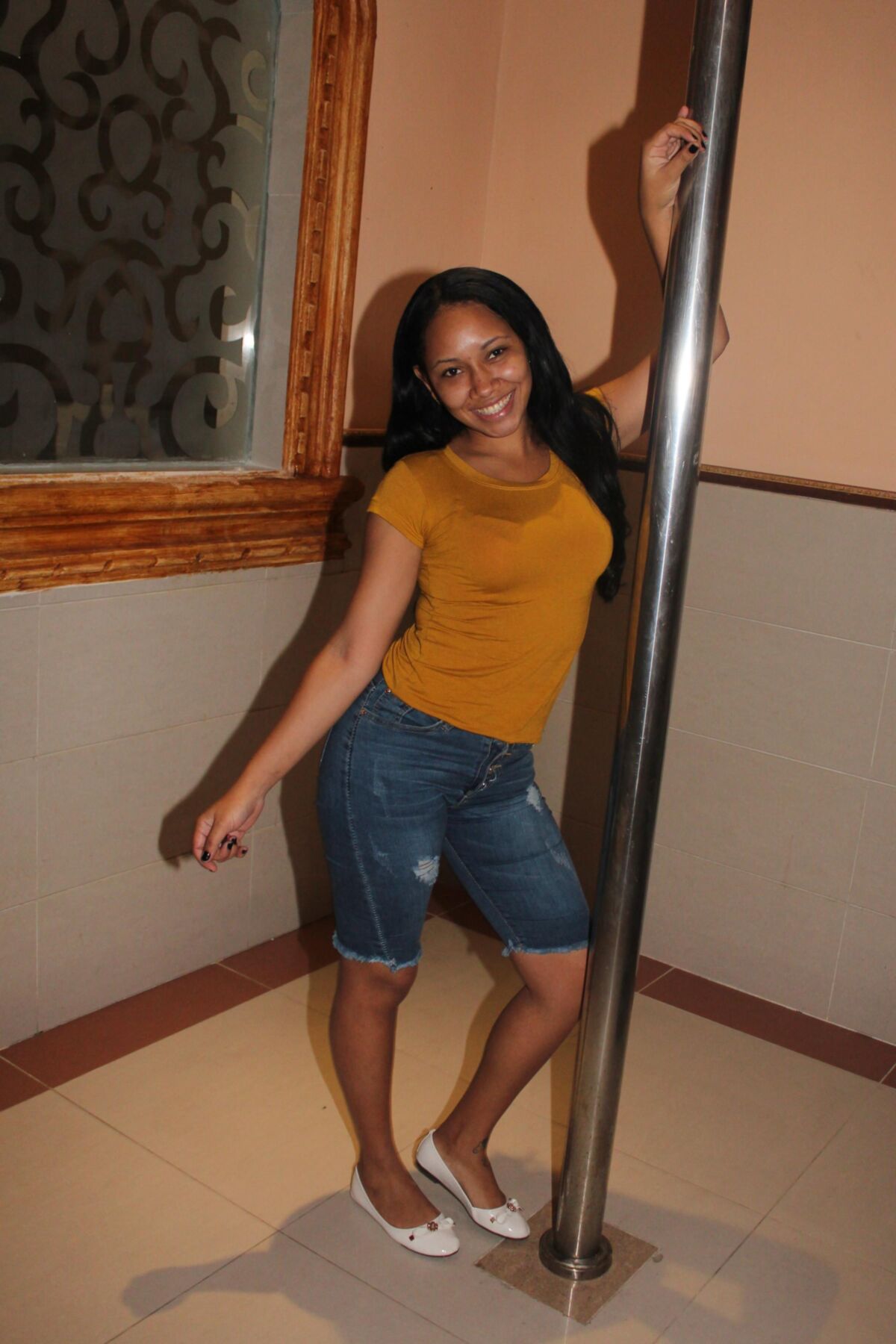 Bonita latina remove sua blusa para mostrar seu sutiã vermelho