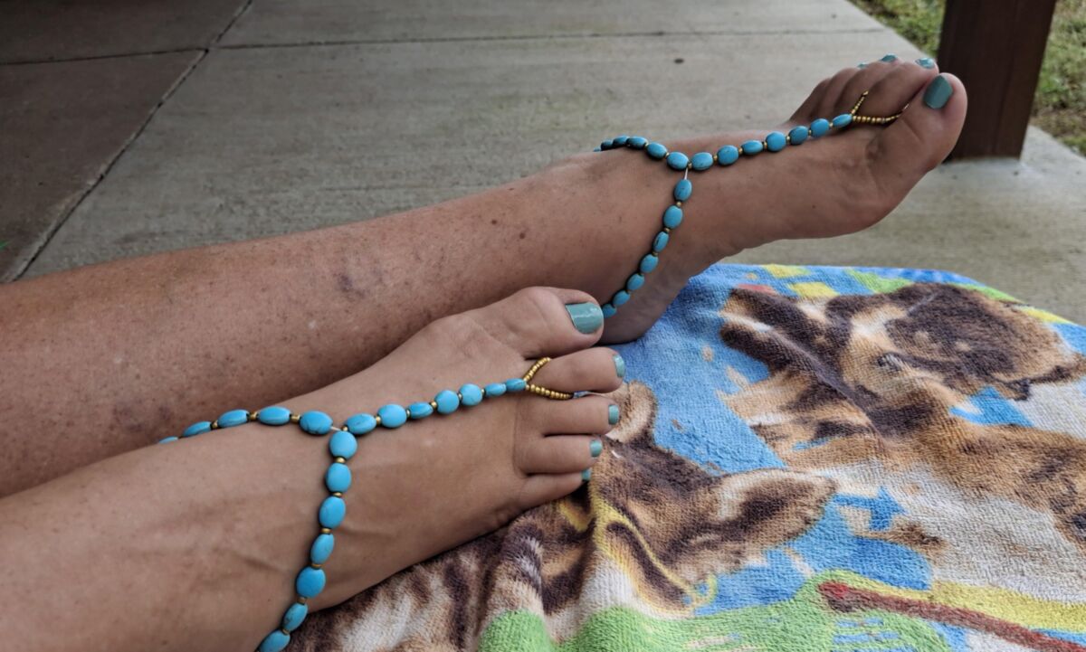 Pés fofos e dedos dos pés pintados em sandálias descalças