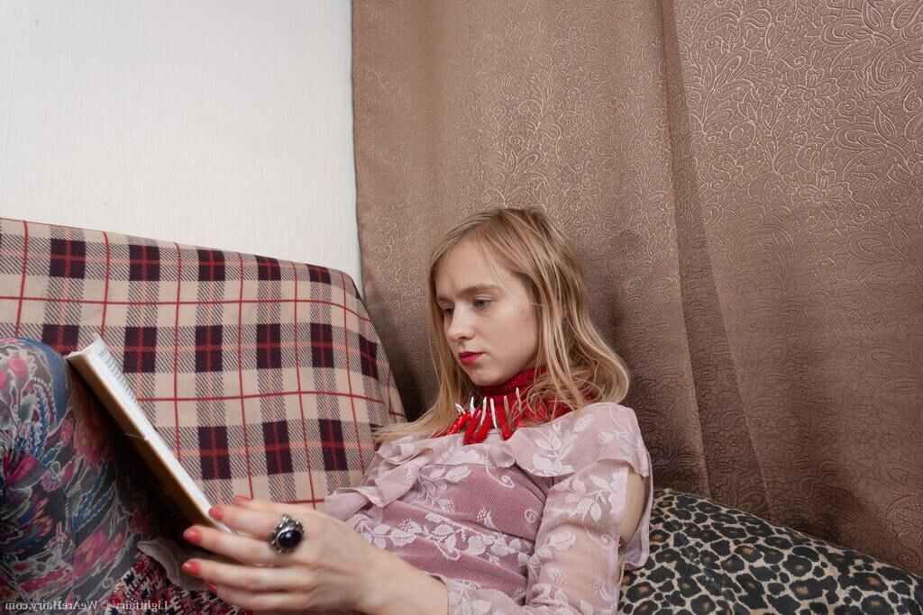 Masturbating on a sofa with a dildo