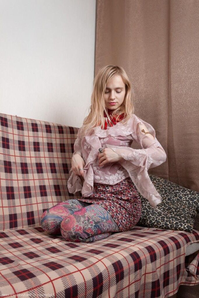 Masturbating on a sofa with a dildo