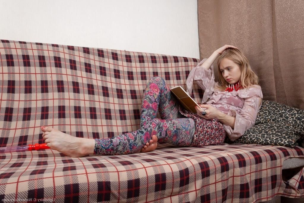 Masturbating on a sofa with a dildo