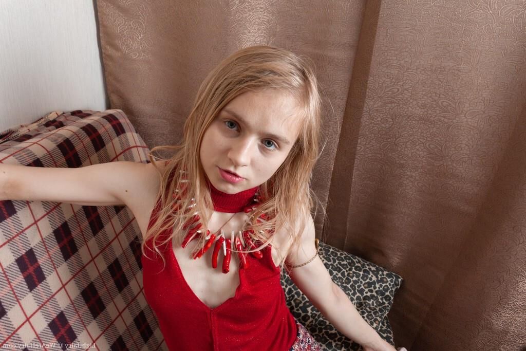 Masturbating on a sofa with a dildo