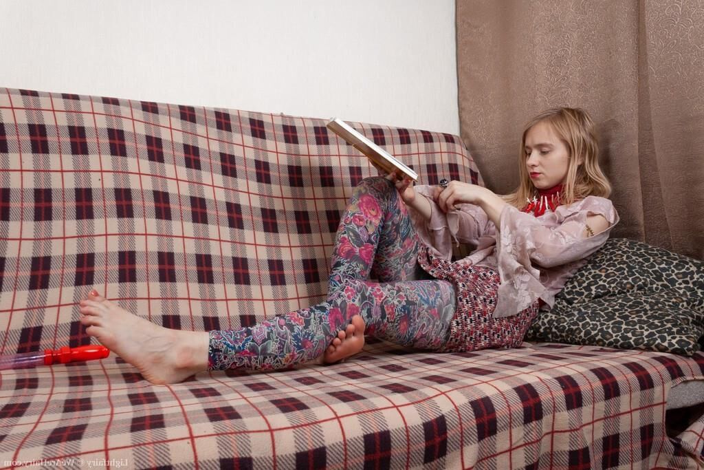 Masturbating on a sofa with a dildo