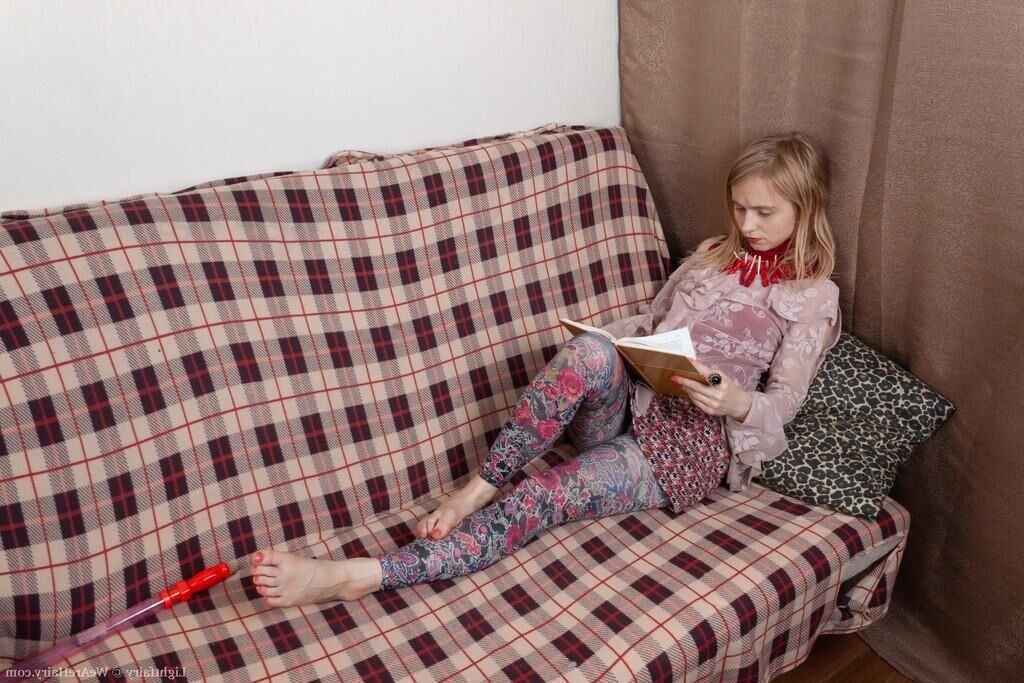 Masturbating on a sofa with a dildo