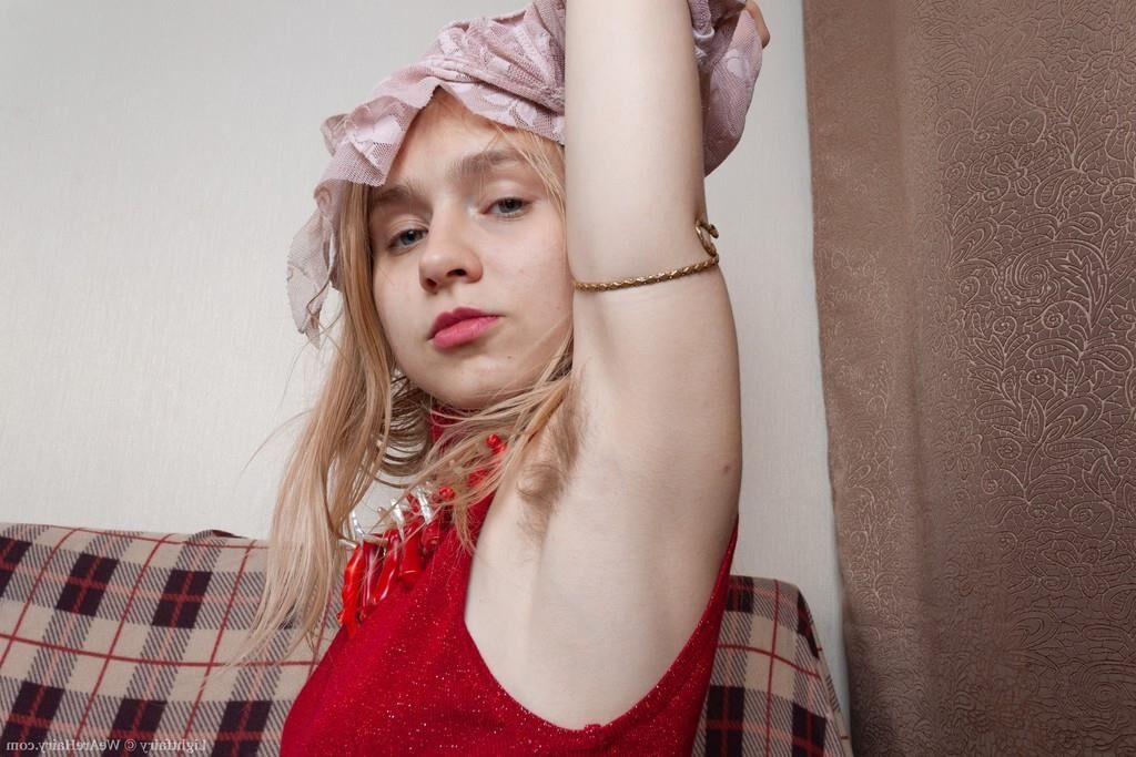 Masturbating on a sofa with a dildo